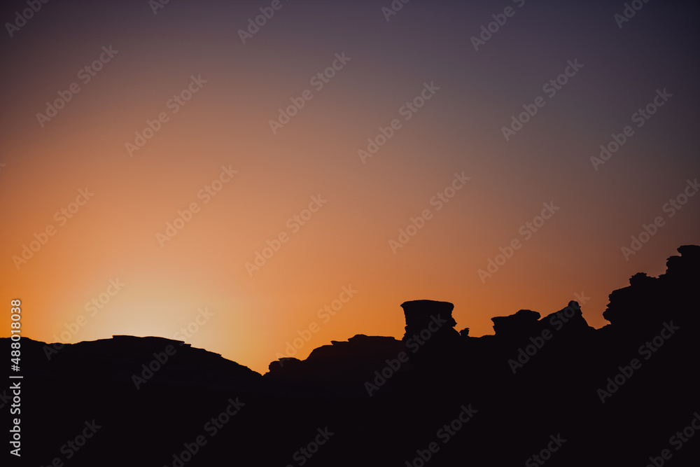 Sunset landscape with rocky mountains silhouette