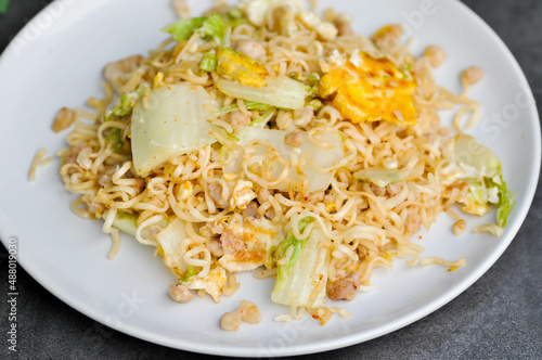 stir fried noodles with pork and vegetable in the pan