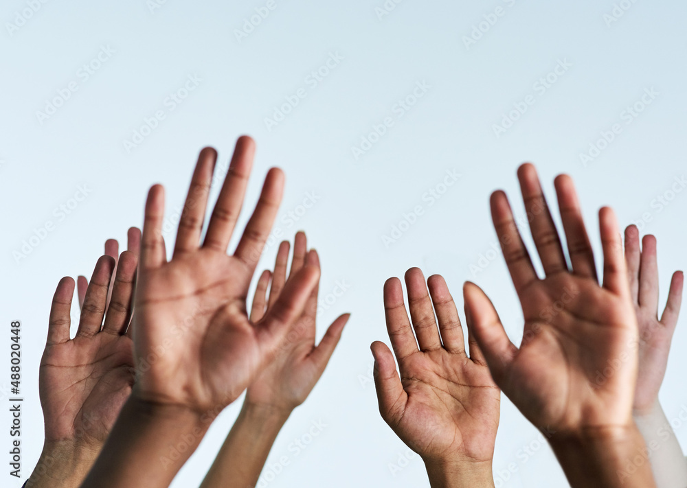 Raise your hands in support of each other. Shot of a group of hands reaching up against a white background. Raise your hands in support of each other. Shot of a group of hands reaching up against a white background.