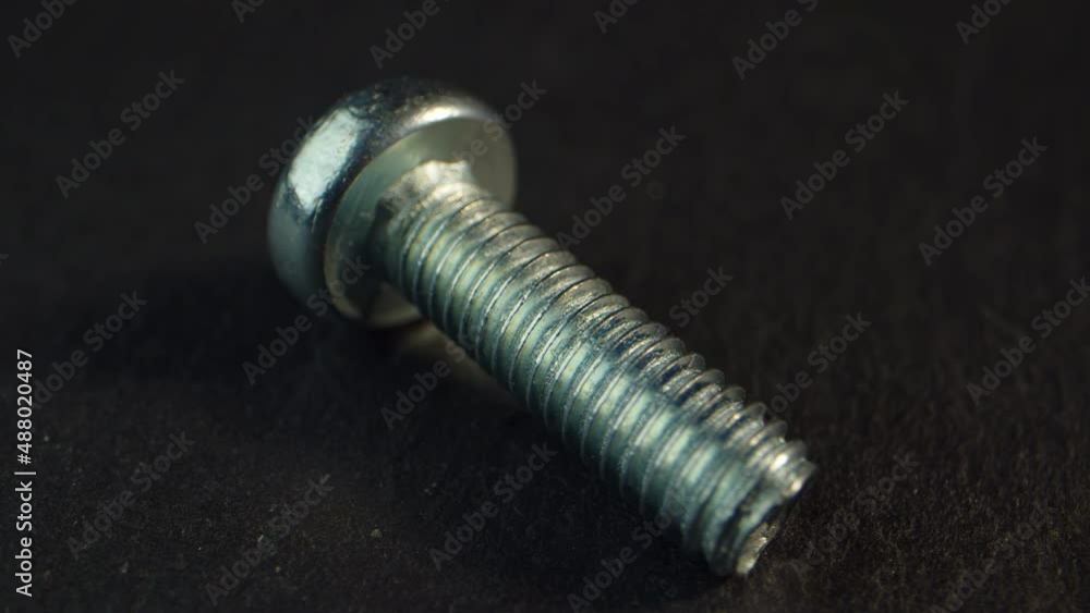 Bolts close-up on a dark background rotating. Fastener. High quality 4k footage Bolts close-up on a dark background rotating. Fastener. High quality 4k footage