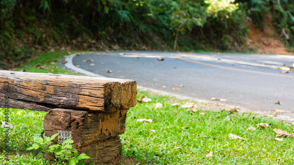 Roadside wooden bench on natural background. Roadside wooden bench on natural background.
