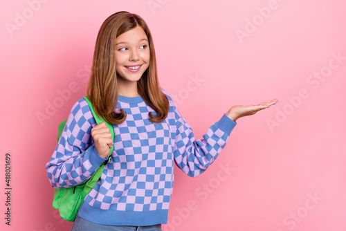 Photo of young girl present product ads select suggest proposition academic isolated over pink color background © deagreez