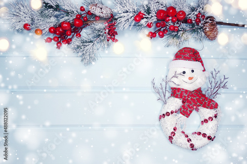 christmas snowman toy with fir branches decor and snow © Anastasia Tsarskaya
