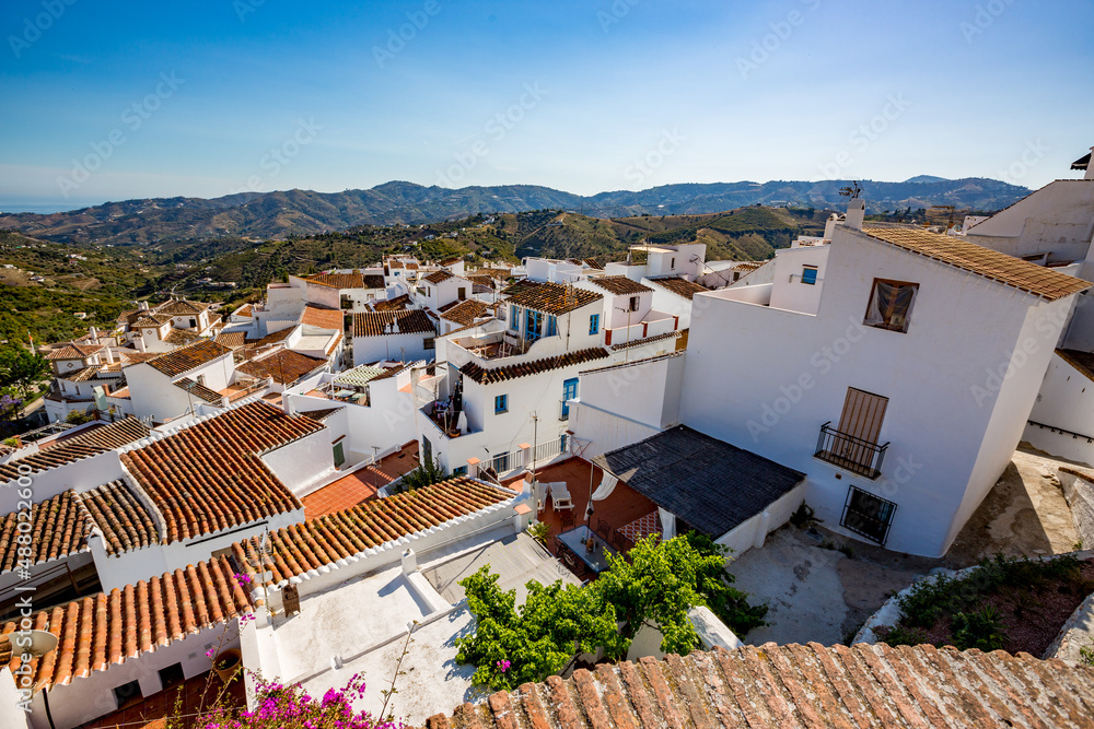 Frigiliana, Malaga, Spain. Sunny spring day street travel view. Roofs and houses
