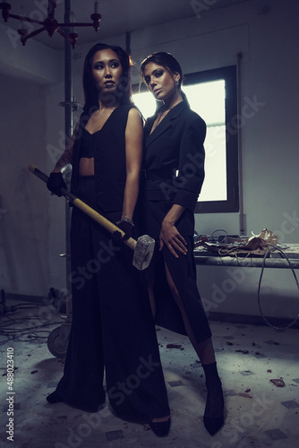 Young women wear black fashion wear posing in studio
