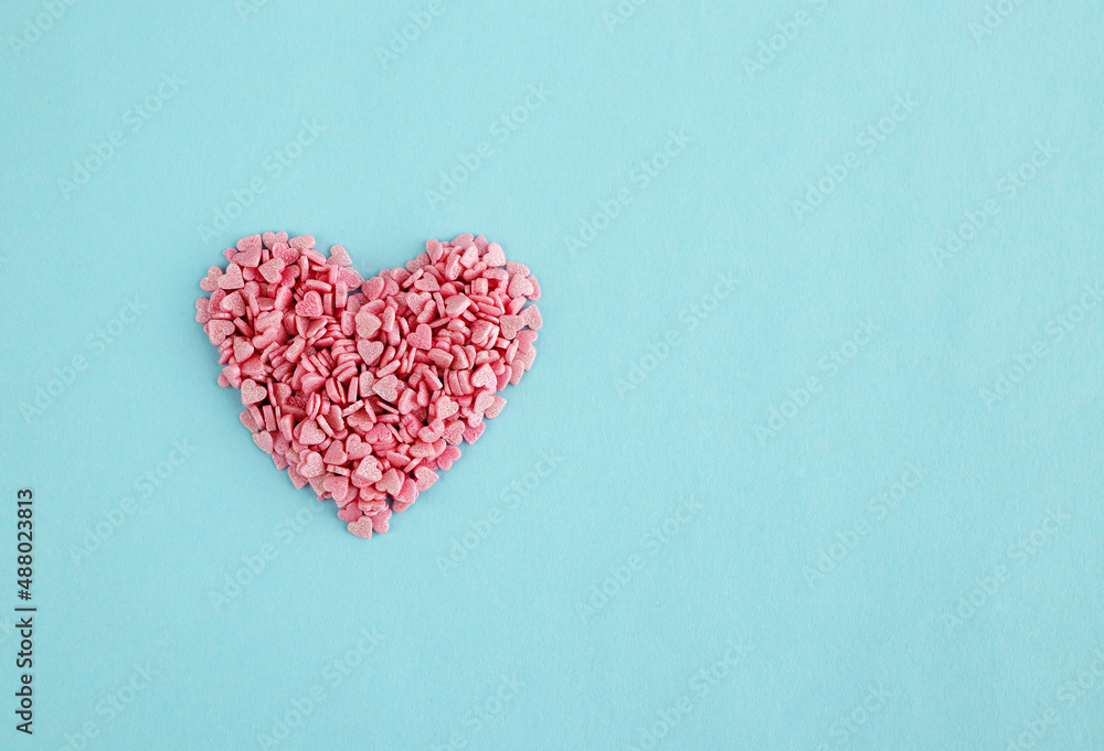 Valentine's Day background. Valentine made of pink confetti on a blue background. Creative Valentine's Day concept Valentine's Day background. Valentine made of pink confetti on a blue background. Creative Valentine's Day concept