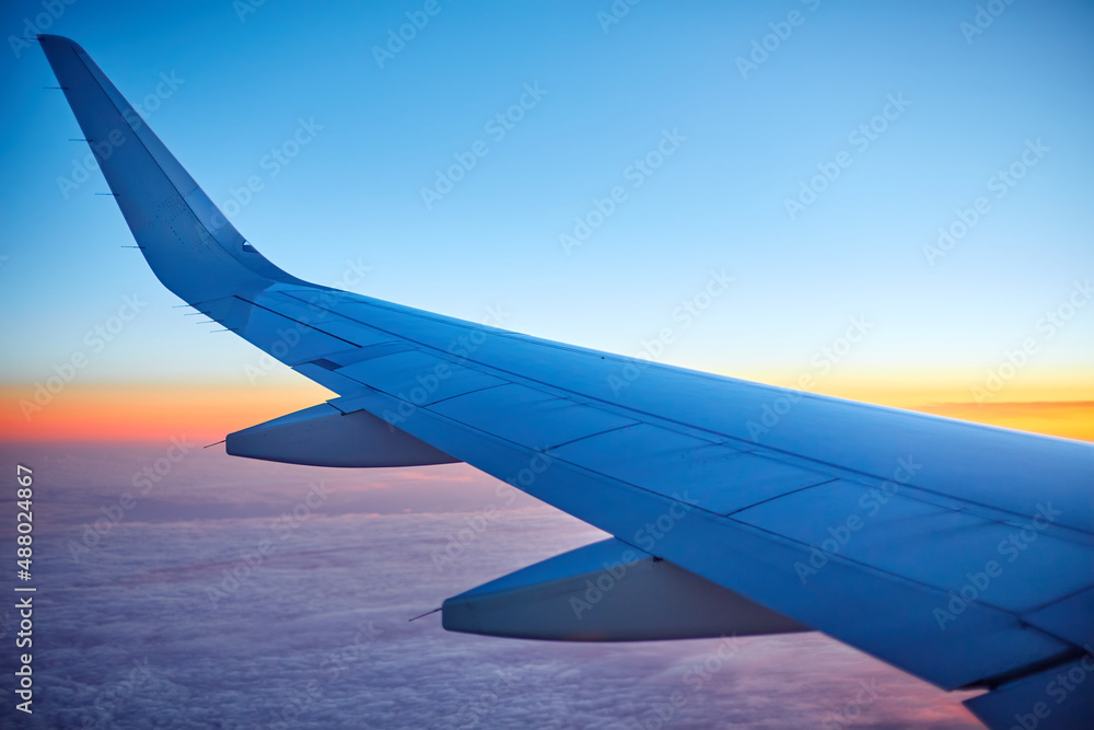Fototapeta premium Morning sunrise. View of the airplane wing from the window