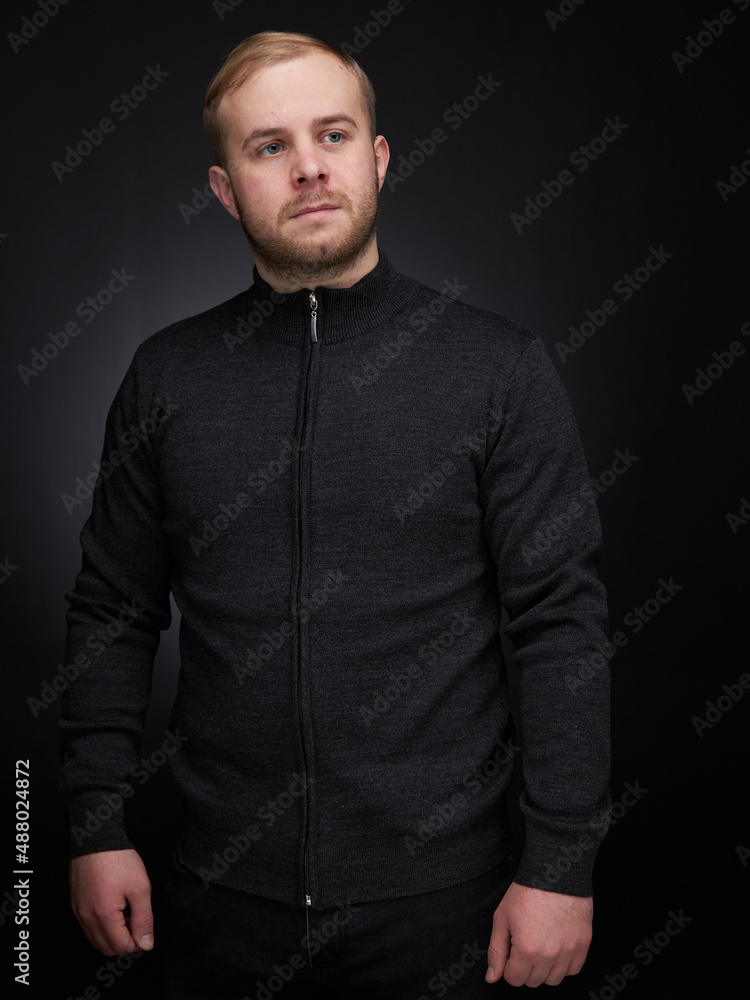 vertical portrait blond man on a dark background, in a jacket vertical portrait blond man on a dark background, in a jacket