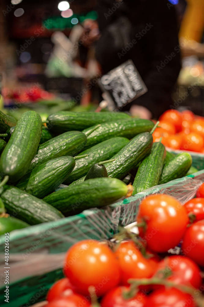 Cucumbers and tomatoes in a grocery store close up
