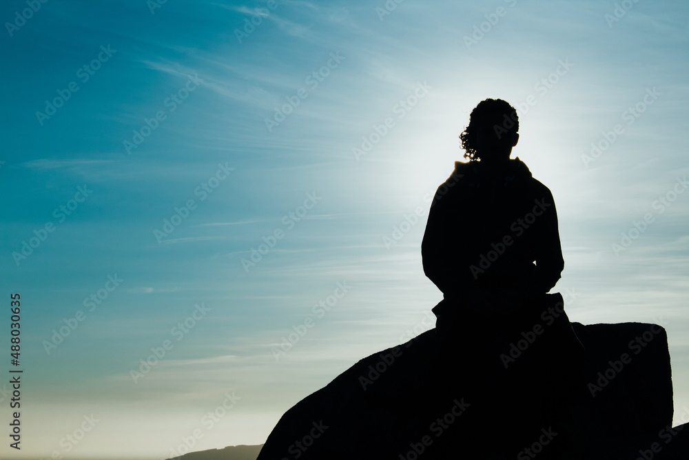 Black silhouette of a man meditating
Black silhouette of a man meditating