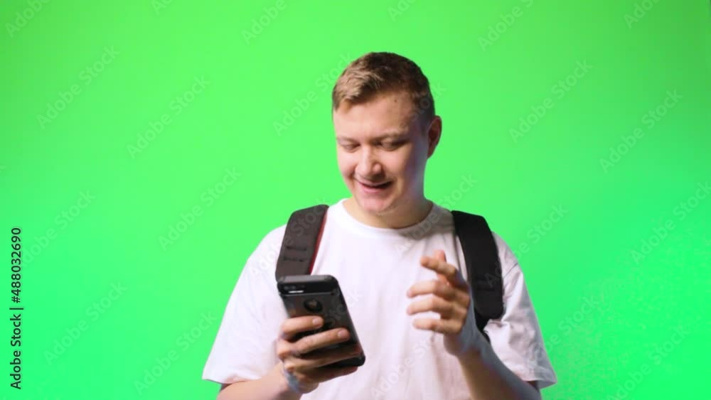 young man student communicates via texting flirting dating chroma key background.concept dating app young man student communicates via texting flirting dating chroma key background.concept dating app