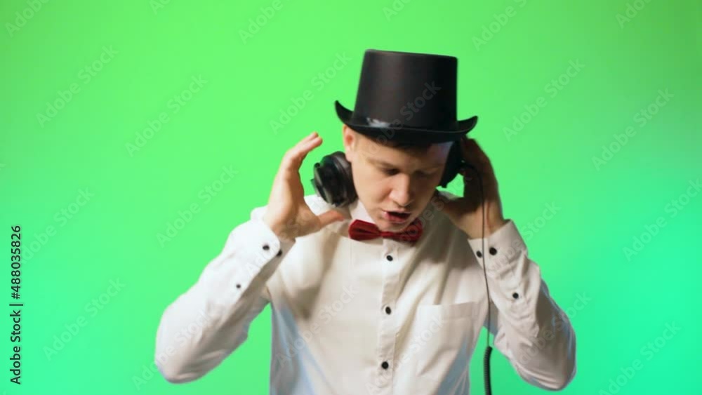 young man artist dj in a hat and bowtie glasses happy performer chromakey music young man artist dj in a hat and bowtie glasses happy performer chromakey music
