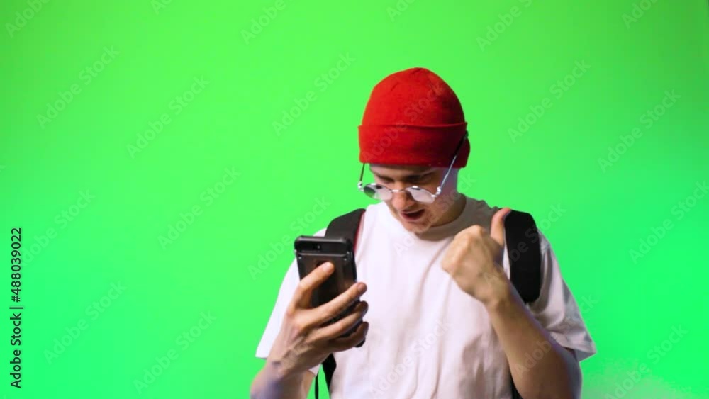 young man hipster rapper speaks via video call chromakey hiphop hat glasses young man hipster rapper speaks via video call chromakey hiphop hat glasses