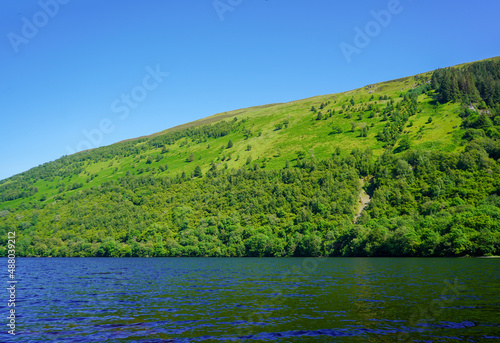 Wallpaper Mural View of a deep blue lake and green hill side forest Torontodigital.ca