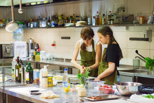 Two woman girl workshop restaurant.