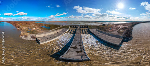 The spillway of the Shapshug reservoir into the Kuban river - aerial panorama on a winter sunny day