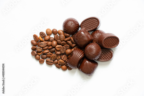 chocolate candies and coffee beans on a white background close up
