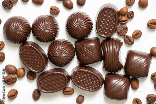 chocolate candies and coffee beans on a white background close up
