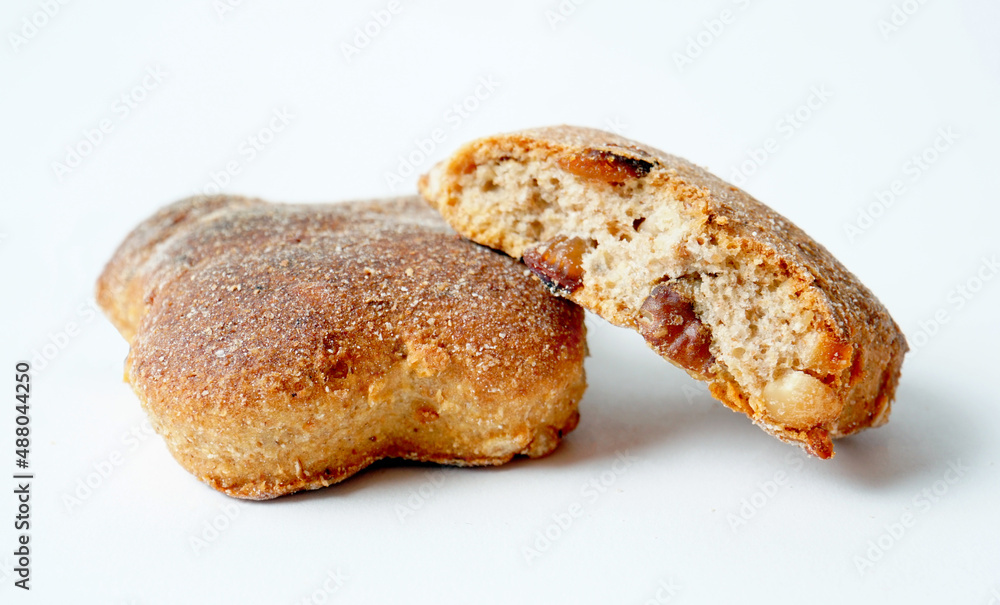 Homemade delicious crunchy cookies with raisins on white background