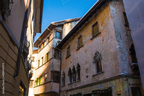 Historic buildings with Christmas decorations in the north east Italian city of Belluno, Veneto region. The building on the right has double lancet windows on the first floor  © dragoncello