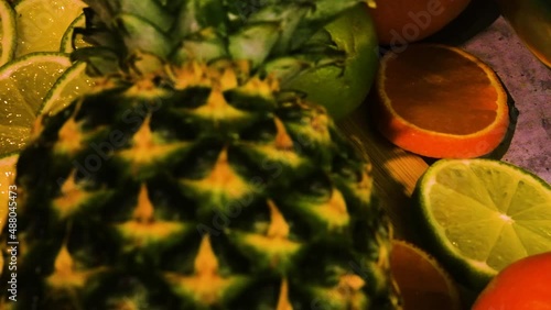 Pineapple, orange,lime, green apple and bananas on the table in high quality