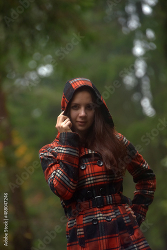 girl in a plaid coat in the autumn park