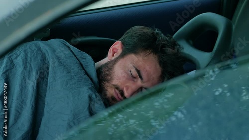 Boy in economic difficulty sleeping in his car in the morning photo
