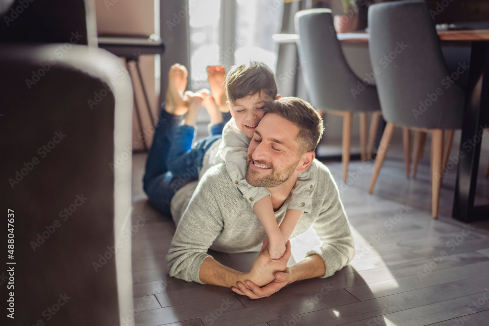 Father or Godfather having fun on the apartment floor At Home Father or Godfather having fun on the apartment floor At Home
