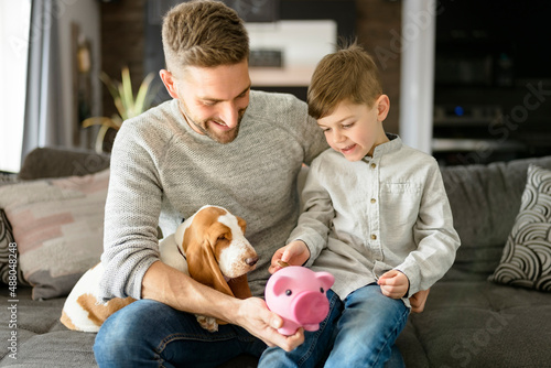 Cuadro en lienzo Father or Godfather with Basset dog having fun on the living room At Home puting