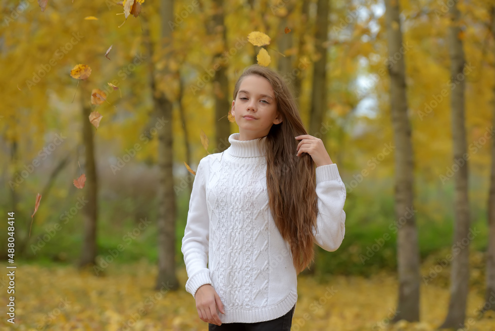 girl brunette child in white sweater in autumn in the park girl brunette child in white sweater in autumn in the park