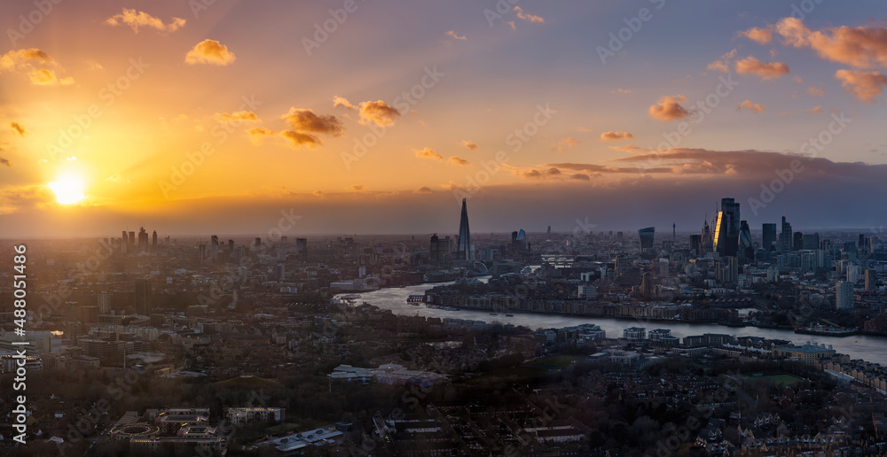 Wide panoramic view of the urban skyline of London, England, during a colorful sunset
