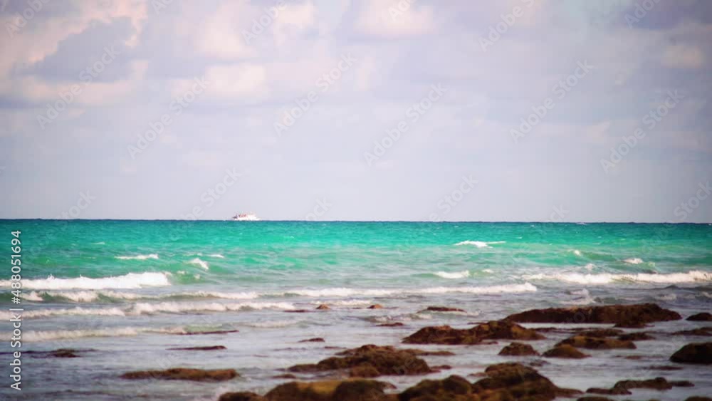 panning shot showing small cruise ship ferry of macruzz moving on the horizon while the blue green waters extend to foreground showing tropical havelock andaman nicobar india panning shot showing small cruise ship ferry of macruzz moving on the horizon while the blue green waters extend to foreground showing tropical havelock andaman nicobar india