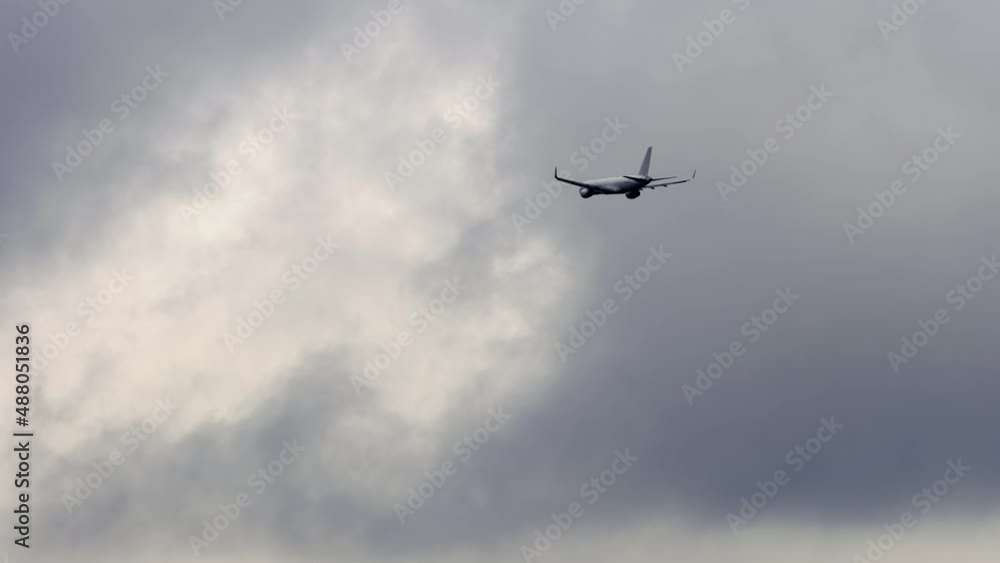 Airplane in cloudy gray sky Airplane in cloudy gray sky