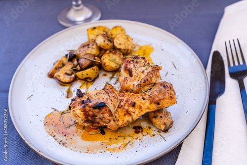 High view of some delicious baked chicken legs with rustic potatoes and some delicious boletus sauteed in EVOO and Spanish paprika.