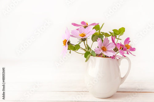 Wallpaper Mural Fresh delicate pink flowers in white jar on rustic white wooden background. Torontodigital.ca