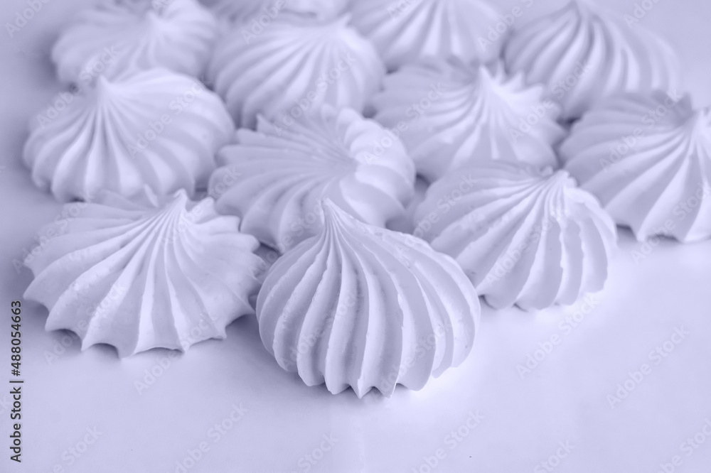 Obraz premium freshly baked meringue cookies on a light background. Beautiful meringue background closeup with blur