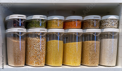 Plastic containers with various cereals and grains. Food storage concept.
