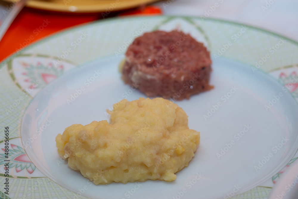 plate of cotechino and puree closeup on table plate of cotechino and puree closeup on table