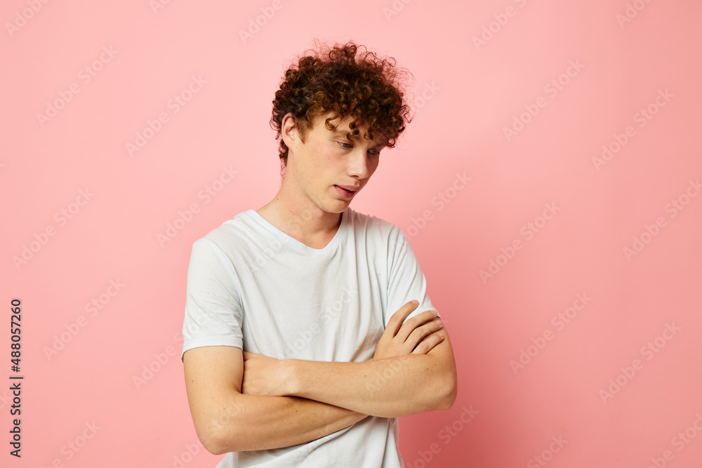 portrait of a young curly man posing youth style white t-shirt isolated background unaltered portrait of a young curly man posing youth style white t-shirt isolated background unaltered
