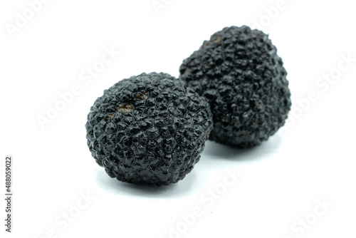 black mushrooms truffles ​​isolated on white background