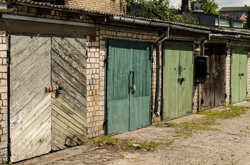 Wooden garage doors of different colors, Ventspils, Latvia. © Bargais