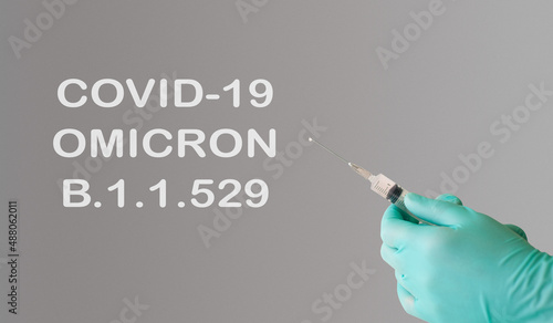 A doctor holds a vaccine against a new variant of omicron covid-19. Vaccine against the South African variant of the coronavirus covid-19 omicron B.1.1.529 photo