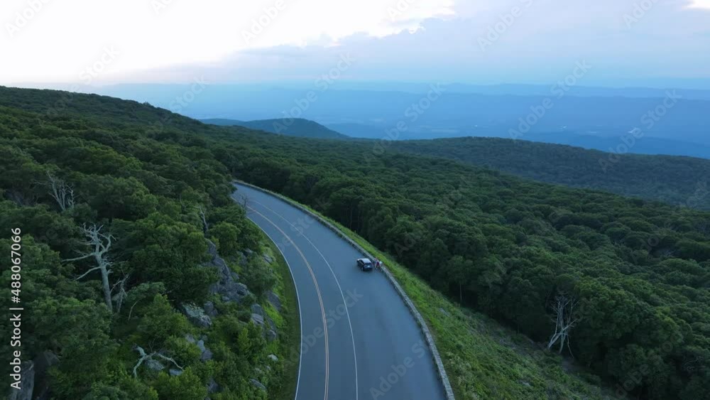 2022 - Excellent aerial view of a car stopped on the Blue Ridge Parkway in Virginia. 2022 - Excellent aerial view of a car stopped on the Blue Ridge Parkway in Virginia.