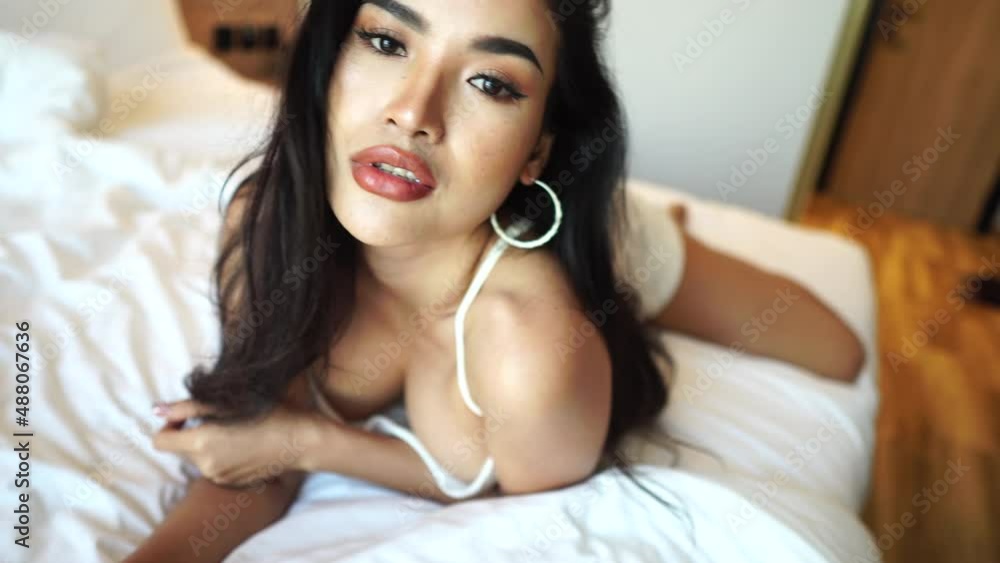 Sexy Asian Beauty Lying on Bed in Nightdress and Posing to Camera