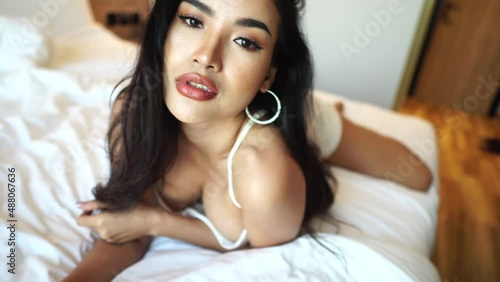 Sexy Asian Beauty Lying on Bed in Nightdress and Posing to Camera