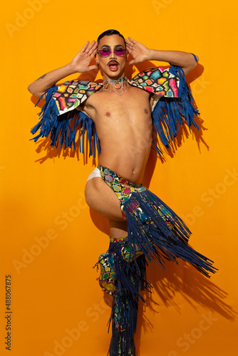 Konstfotografi beautiful drag queen in colorful dress on yellow background