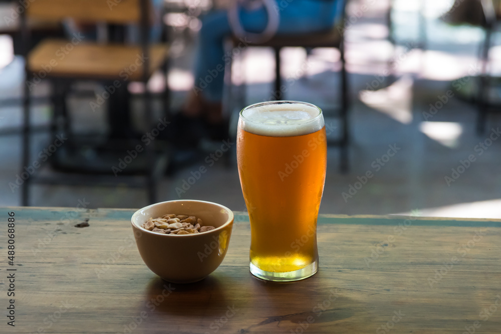 craft beer next to salted peanuts craft beer next to salted peanuts