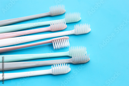 Toothbrushes on blue background. Top view