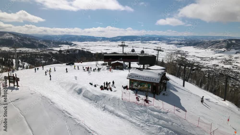 2022 - Excellent aerial view of skiers getting off the ski lift at Steamboat Springs, Colorado. 2022 - Excellent aerial view of skiers getting off the ski lift at Steamboat Springs, Colorado.