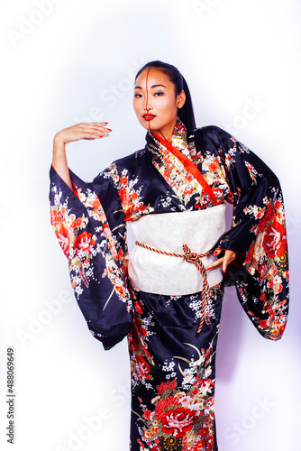 Obraz na plátně young pretty geisha in black kimono posing isolated on white background, asian e